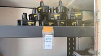 Stack of DeWalt 18V battery packs on shelf