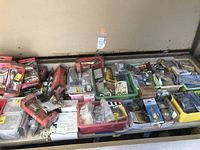 Tray showing overall assortment of packaged and loose hardware