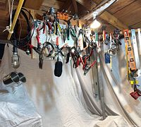 Overall view of pegboard with assorted hand tools, work light and accessories