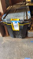 Closed heavy duty plastic tool box with lot label
