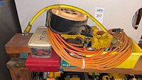Overview of extension cord coiled, distribution blocks, cord reel and storage bins
