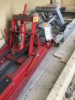 Red Team Mechanix jack and grey utility lift on shelf