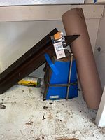 Microfilm reader, roofing paper roll, steel angle bar and can in cabinet