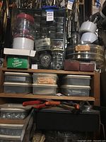 Overall view showing multiple containers of fasteners, drawer cabinet, garden shears