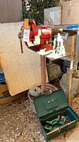 Olympia bench vise on stand with tool box of clamps