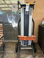 Front view of folded Ridgid MS-UV stand showing wheels, handles, mounting rails