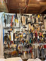 Full view of pegboard filled with assorted hand tools