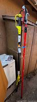 Ryobi pole saw and Corona pruner standing upright