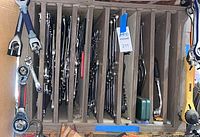 Vertical rack holding numerous ratcheting combination wrenches and tool handles