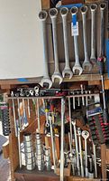 Large wrenches hanging, ratchets and sockets below