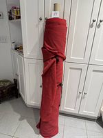 Full roll standing against cabinet