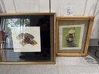 Both framed artworks standing side by side