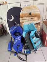 Full lot showing two boogie boards, two life jackets, small football