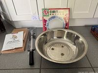 Overview showing stainless bowl, ham stand components, knife, porcelain plate box