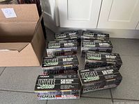 Eight retail boxes of Noma Icicle Lites beside shipping box