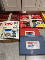 Group shot of all five board games showing titles and taped boxes