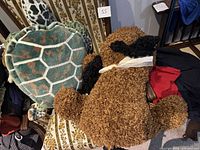Sea turtle and brown dog plush on chair