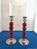 full view of both candlestick holders with candles inserted