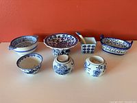 All eight blue and white ceramic pieces arranged together