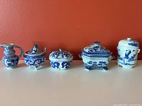 Front view of all five blue-and-white porcelain pieces lined up