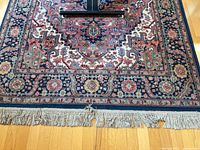 Full width view showing central medallion, border, and fringe