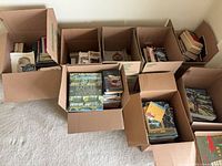 Six moving boxes filled with assorted books