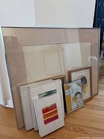 Group shot showing all seven frames leaned against wall, highlighting largest aluminum frame and variety of smaller frames