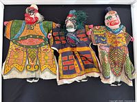 Front view of three vintage Chinese opera hand puppets