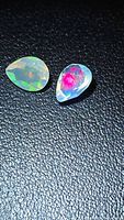 Matching pair of pear-cut faceted Ethiopian opals showing multicolour flashes