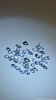 Group of loose oval faceted tanzanites on white background