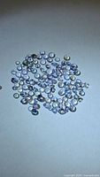 Loose round faceted tanzanite stones spread on surface