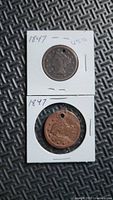Obverse views of both 1847 large cent coins in holders