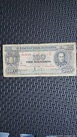 Front of 1945 Bolivia 100 Bolivianos note showing portrait, serial number 8877078, denomination