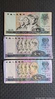 Obverse of all three banknotes showing denomination and portraits