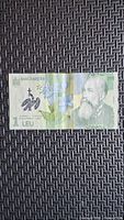 Front of 2006 Romanian 1 leu banknote showing portrait and flowers