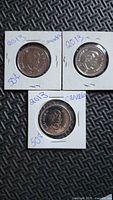 Three 2013 Canada 50-cent coins in holders
