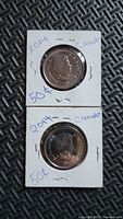 Two 2014 Canada 50-cent coins in cardboard flips