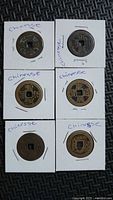 Front view of six Chinese cash coins in flips