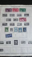 Album page with 21 Newfoundland stamps in various denominations and colours