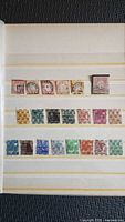 Album page with first two rows of German stamps, various colors and denominations