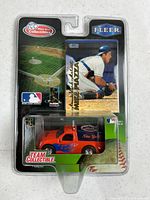 Front view of sealed blister package showing truck and trading card