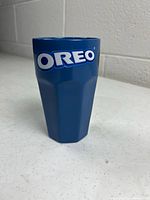 Front view showing blue mug and large white OREO logo