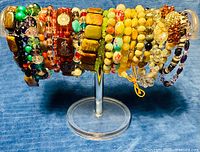 Full lot of assorted stretch bracelets on display stand