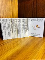 All 23 books standing in order, Apple Dapply’s front cover shown