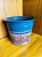 Front view of blue glazed planter with decorative band