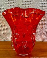 Full view of amberina art glass vase showing ruffled rim and applied clear loops