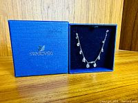Necklace in closed presentation box showing Swarovski logo