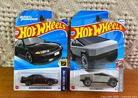 Front view of both factory-sealed Hot Wheels cards showing Tesla Cybertruck and Nissan Skyline GT-R (R32)