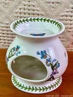 Front view showing open cavity, floral decal, and pattern details