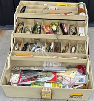 Overall view of open Plano tackle box showing trays full of assorted tackle
